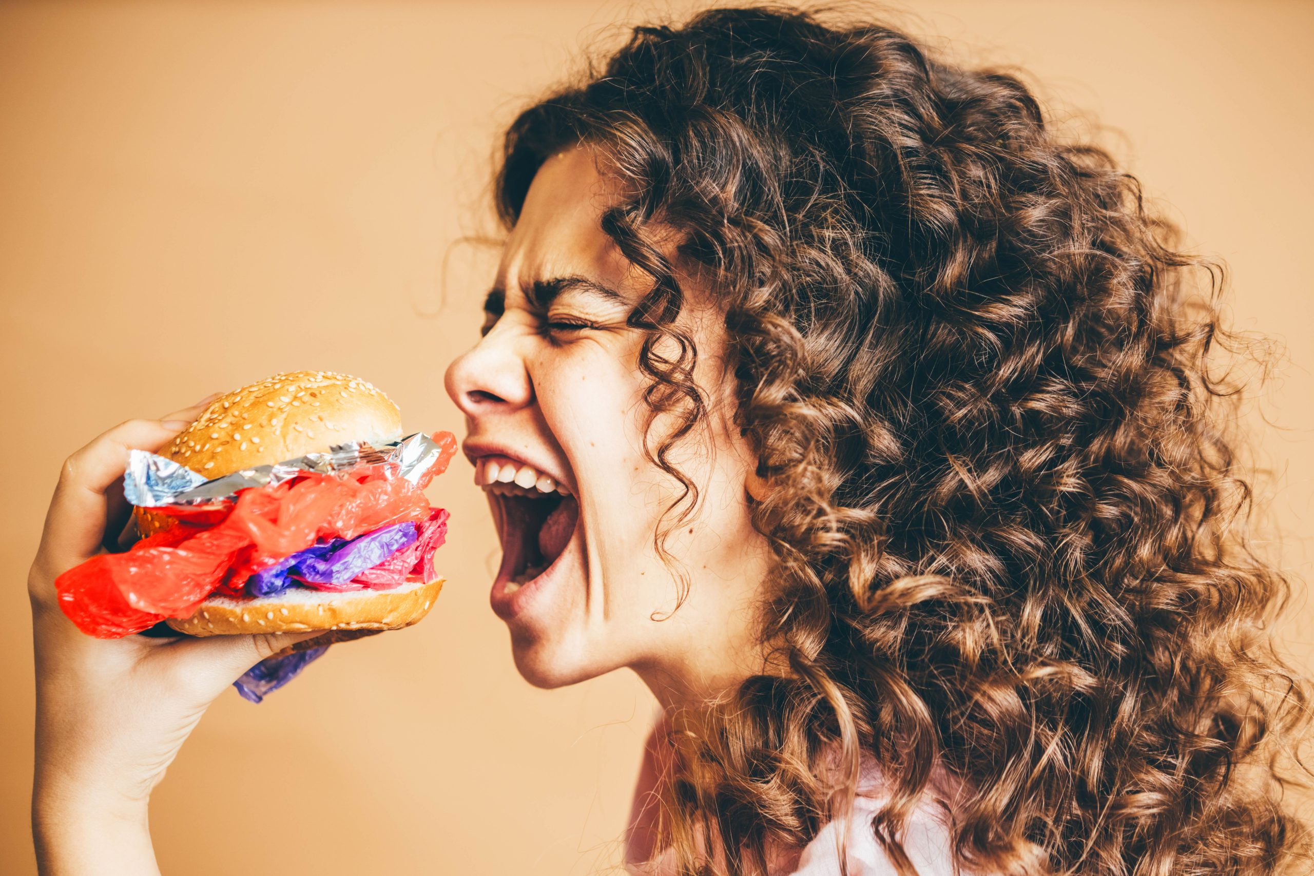 woman-eating-plastic-burgers